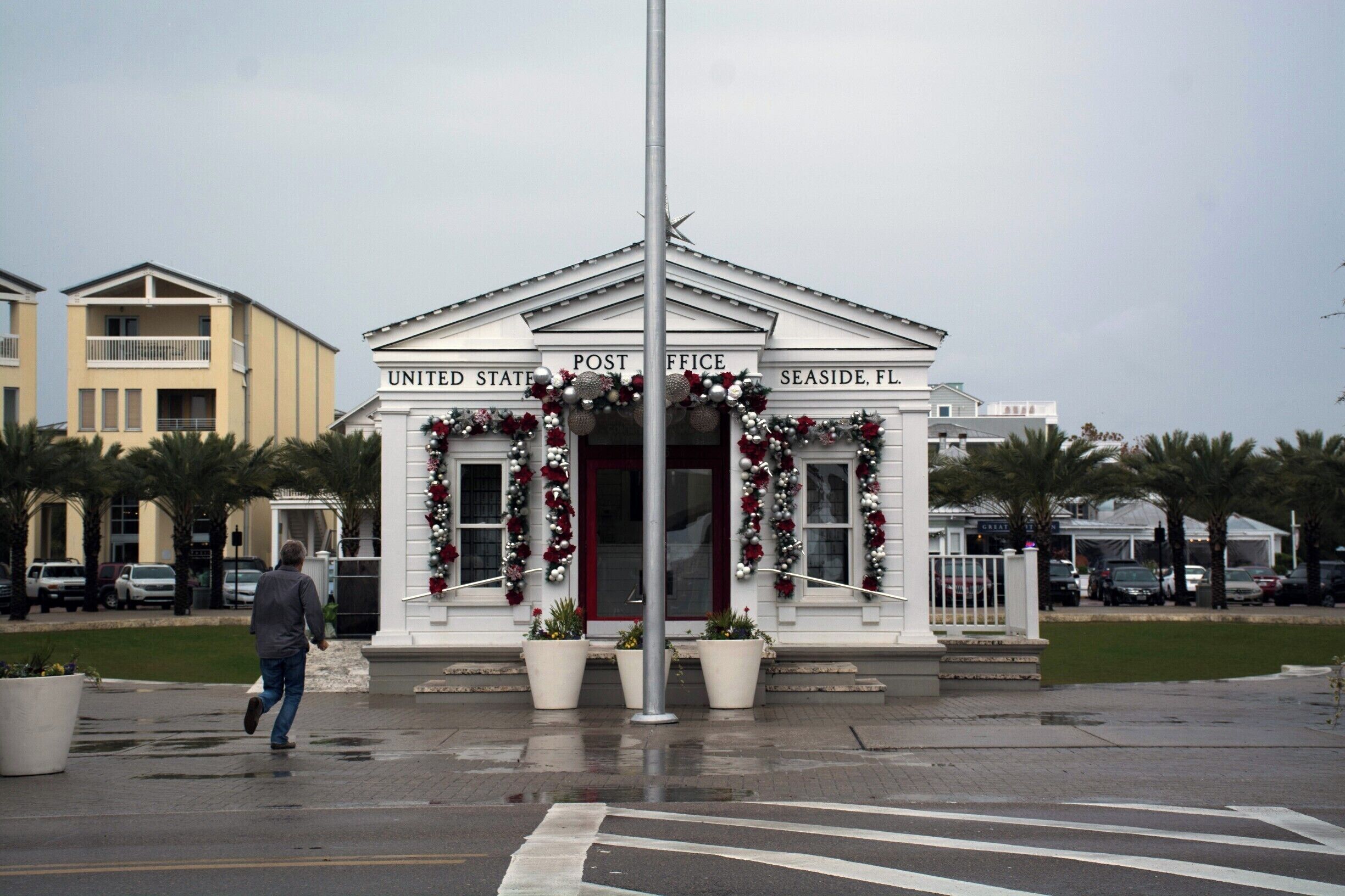 A United States Post Office in Seaside, FL, decorated with festive wreaths and flowers.