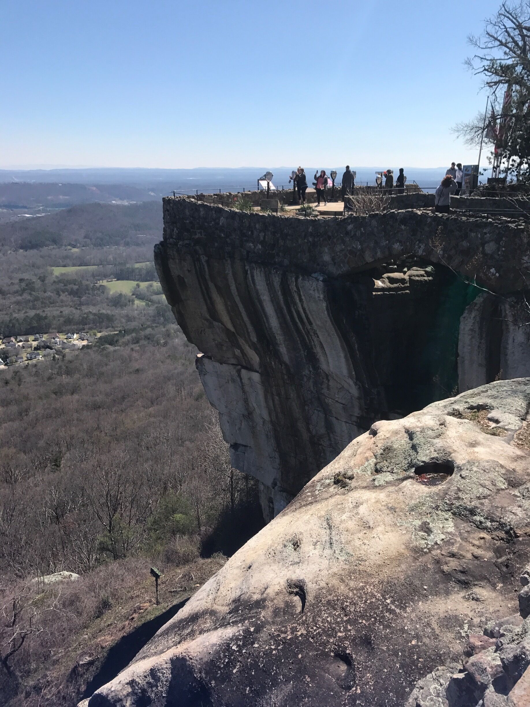 A rocky cliff with a viewing platform.