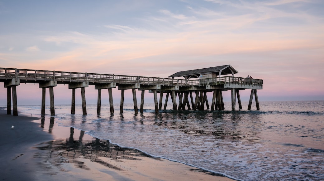 Wide angle view of the Tybee Island Pier in Georgia. Colorful sunset with pinks and purple colors in the sky