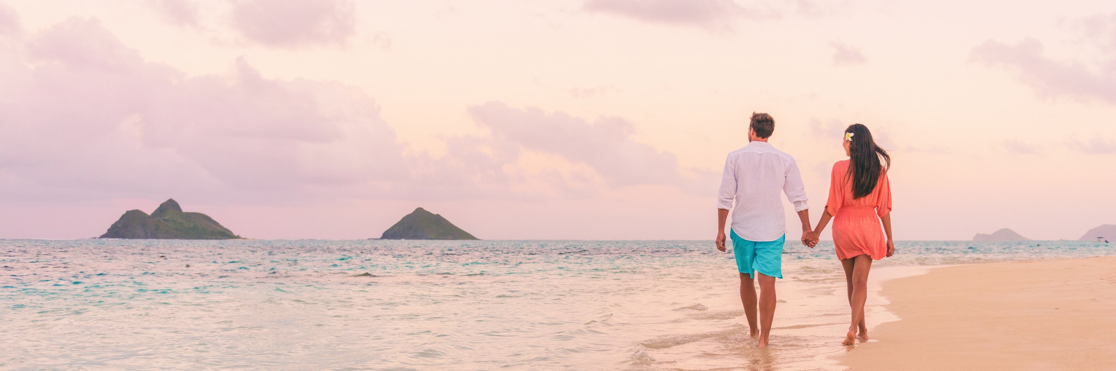 Beach vacation panoramic background romantic walk couple relaxing on Hawaii ocean summer travel destination.