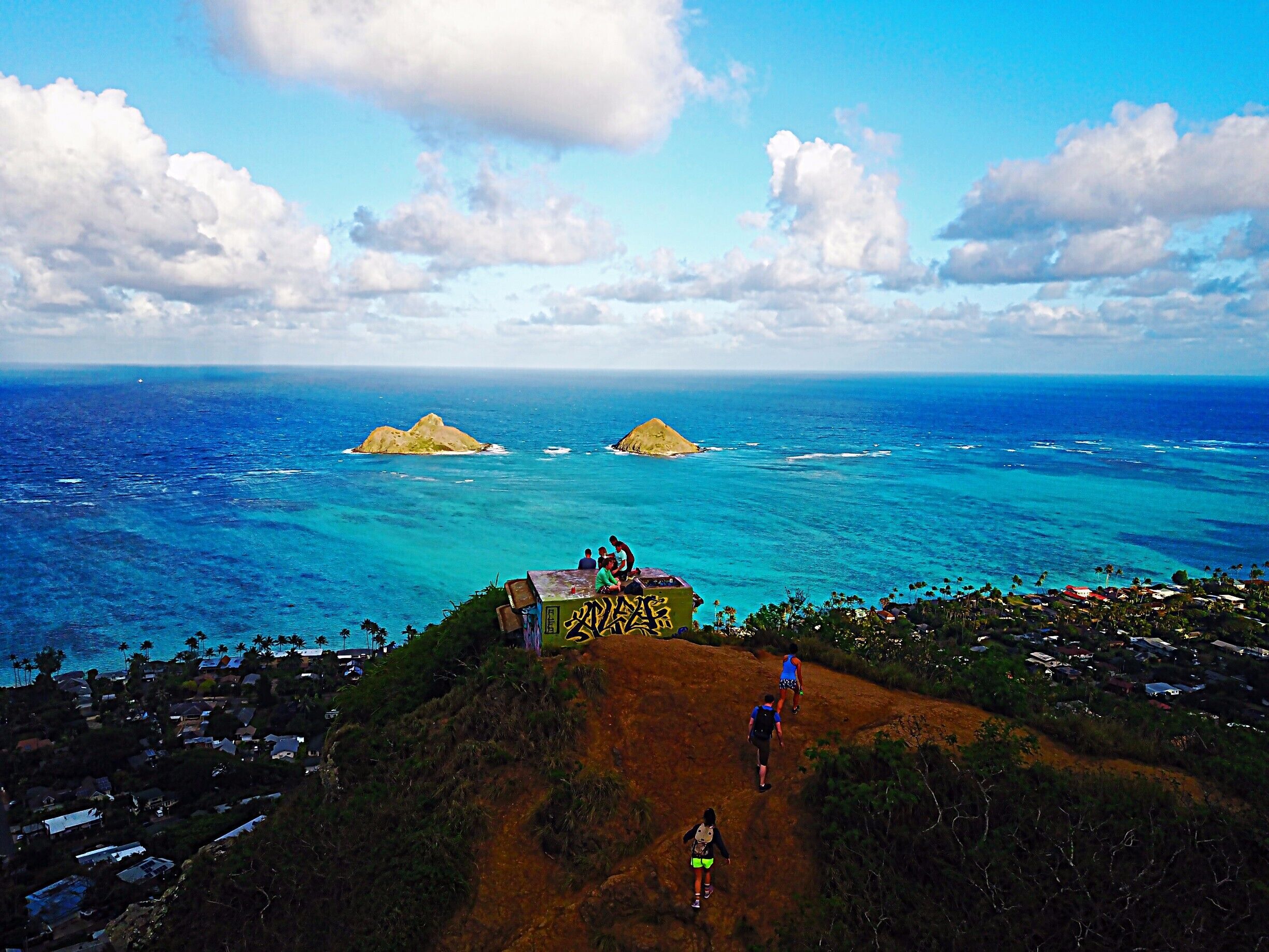 With a spectacular view of Lanikai Beach below, Lanikai Pillboxes Hike is one of my favorite places on Oahu, HI. In the distance you can see The Mokes islands. The hike is pretty short, maybe a half hour to hour up to the top where there are a few pillboxes like the one in this photo. #lifeatexpedia