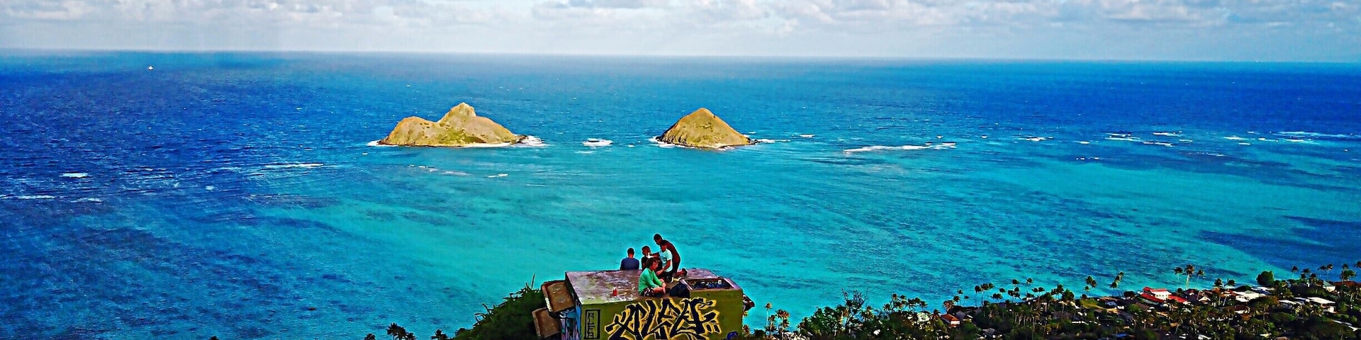 With a spectacular view of Lanikai Beach below, Lanikai Pillboxes Hike is one of my favorite places on Oahu, HI. In the distance you can see The Mokes islands. The hike is pretty short, maybe a half hour to hour up to the top where there are a few pillboxes like the one in this photo. #lifeatexpedia