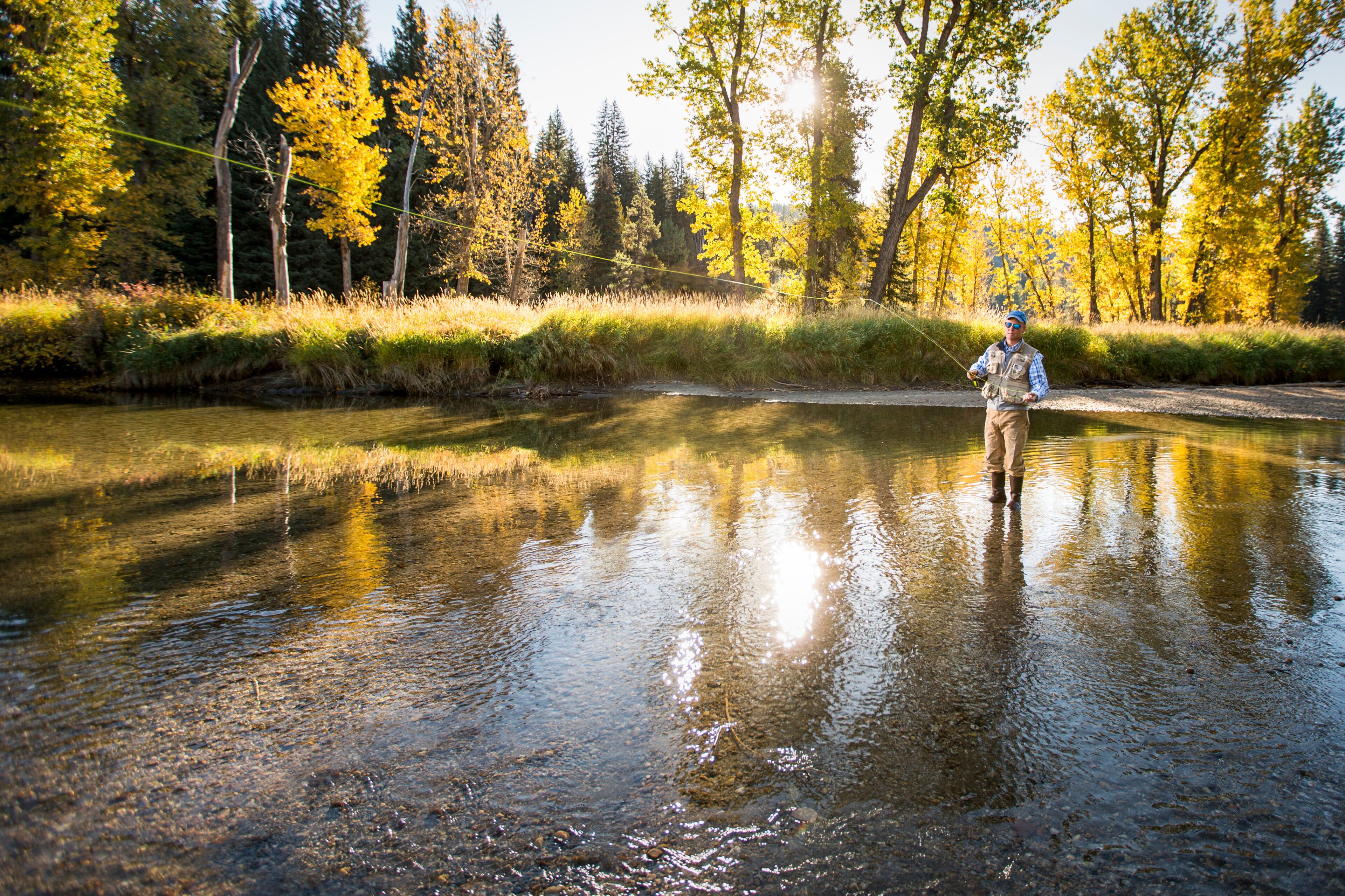 Man fly fishing on North Fork of Payette River, Idaho, USA