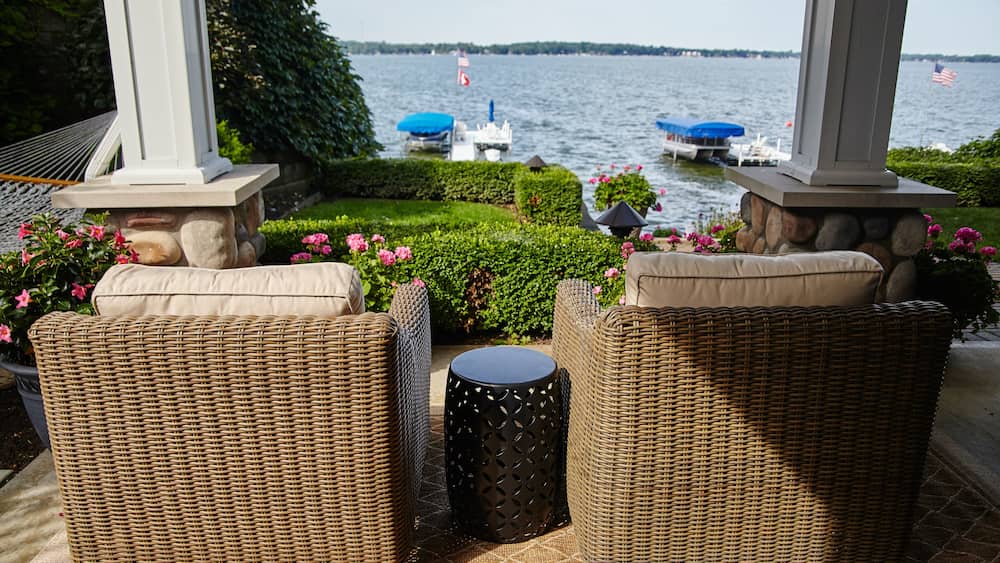 Lakeside Relaxation with Wicker Chairs and American Flag