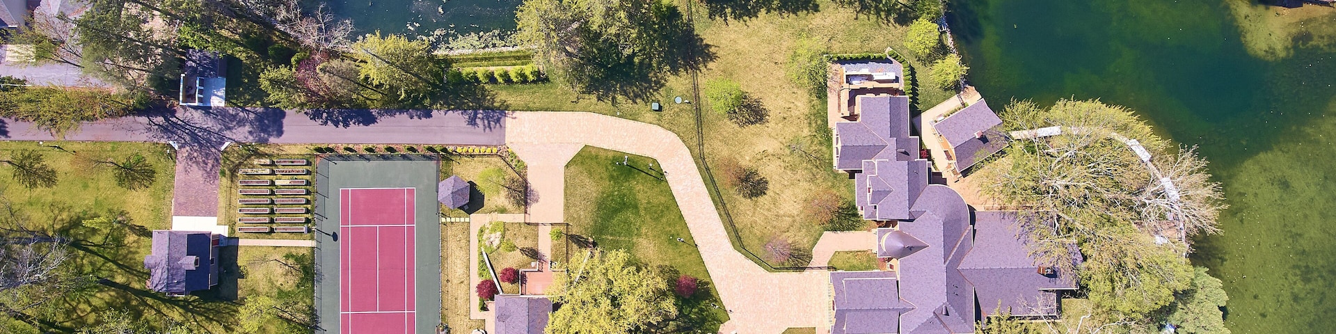 Peninsula sandwiched between lake and river downward lake house property containing tennis court