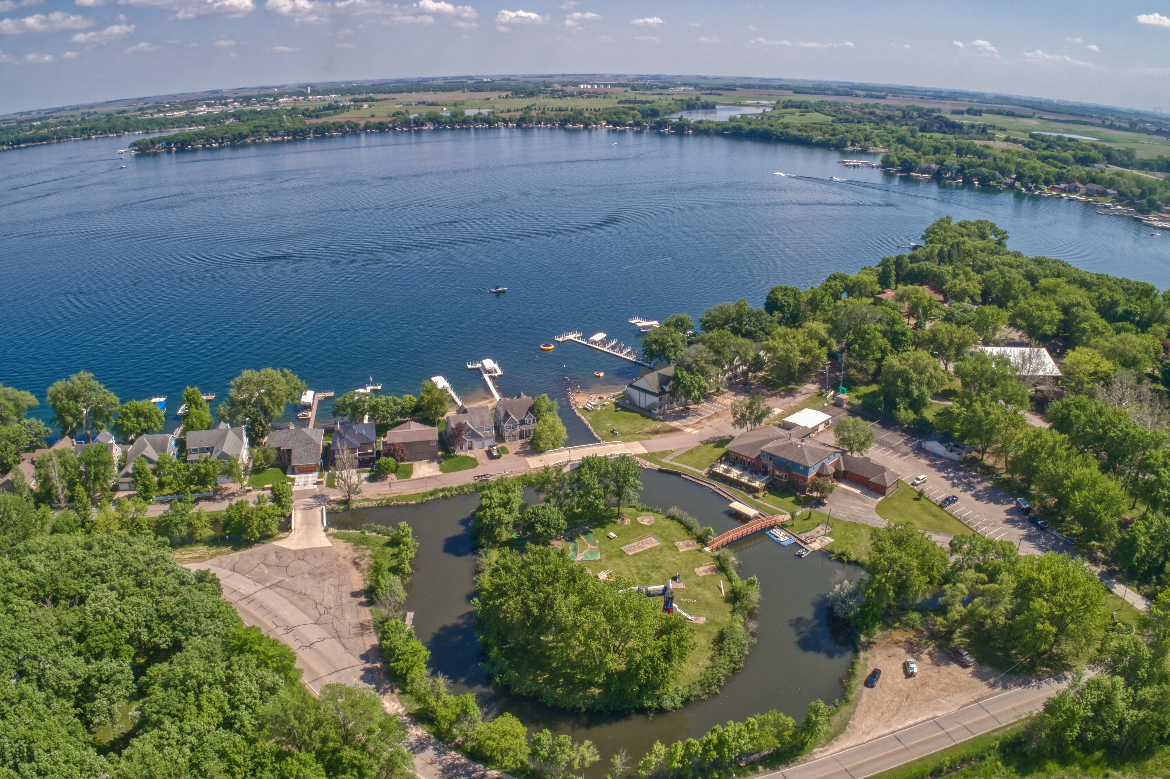A lakeside community with boats, docks, and residential houses.