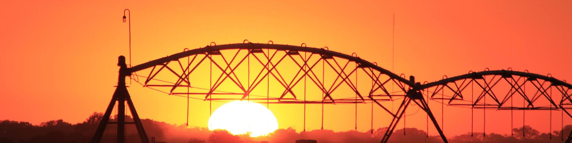 Irrigation System silhouette at Sunset with a colorful sky south of Lyons Kansas USA.