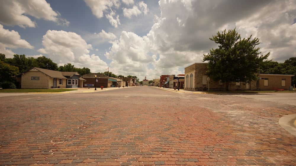 old town street of brick with awesome clouds