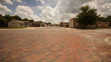 old town street of brick with awesome clouds
