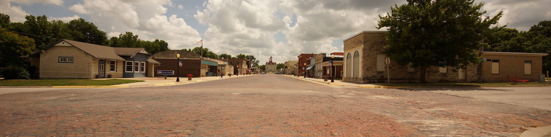 old town street of brick with awesome clouds