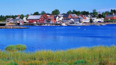 USA, Maine, Damariscotta. The quaint village of Damariscotta, in Lincoln County, Maine, is a montage of bright red and white buildings on its pretty blue harbor.