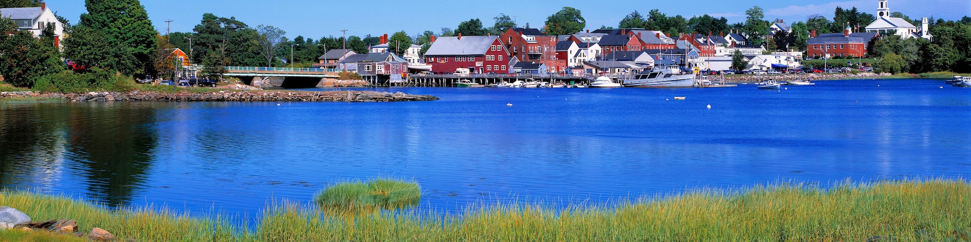 USA, Maine, Damariscotta. The quaint village of Damariscotta, in Lincoln County, Maine, is a montage of bright red and white buildings on its pretty blue harbor.
