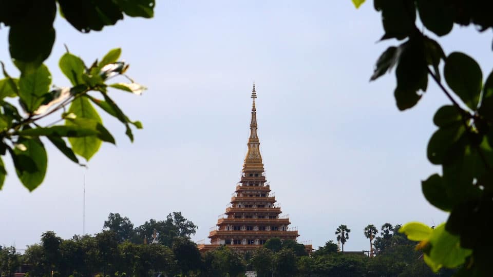 Wat Nong Wang, the tallest temple in E-san, overlooks Bung Kaenakorn, a sizable lake and surrounding park. Visitors to the temple may climb to the 9th floor to observe the bustle of the city or to pray. The way to the top winds past historic offerings and moralistic murals as well as the personal effects of important monks. The view is worth the climb but if you're tall, watch your head.
#architecture #green