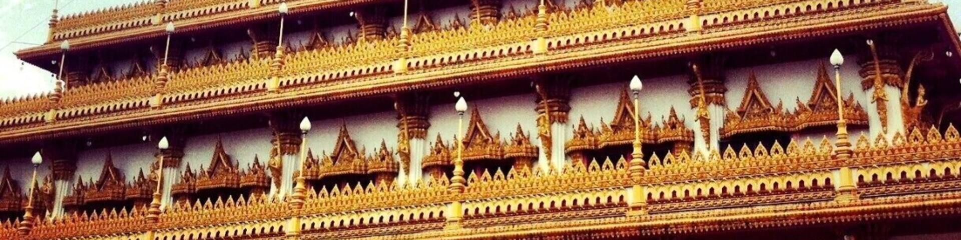 A multi-tiered temple with ornate golden decorations and pointed roofs.