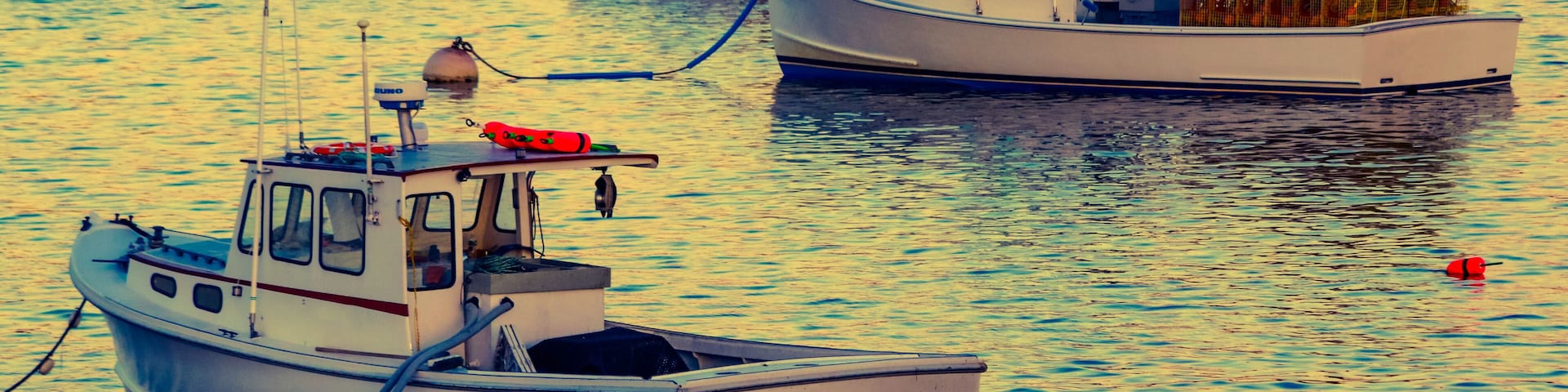 Lobster boats moored in the Sheepscot River at the Wiscasset Waterfront at sunset