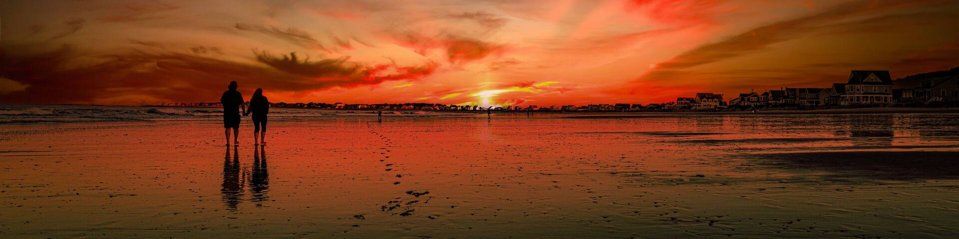 Tranquil summer sunset seascape panorama in silhouette on the Fortunes Rocks Beach, a popular family outdoor activities in Biddeford, York County, Maine, USA