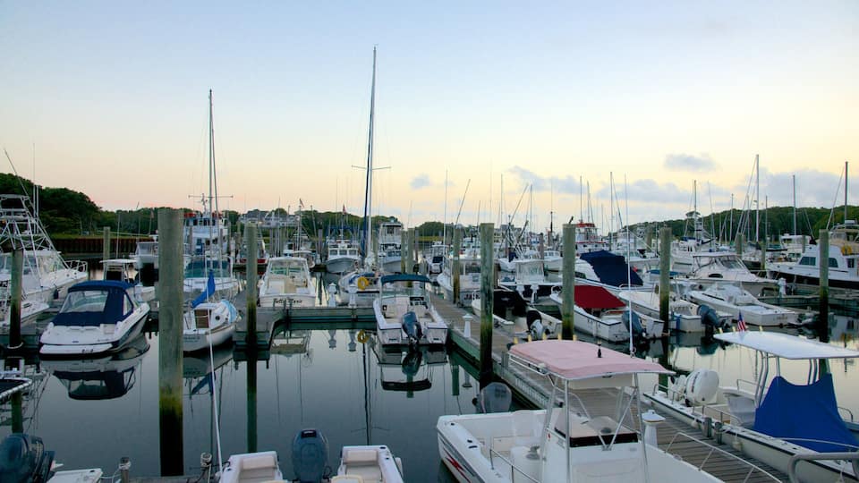 A marina filled with various boats docked at wooden piers.