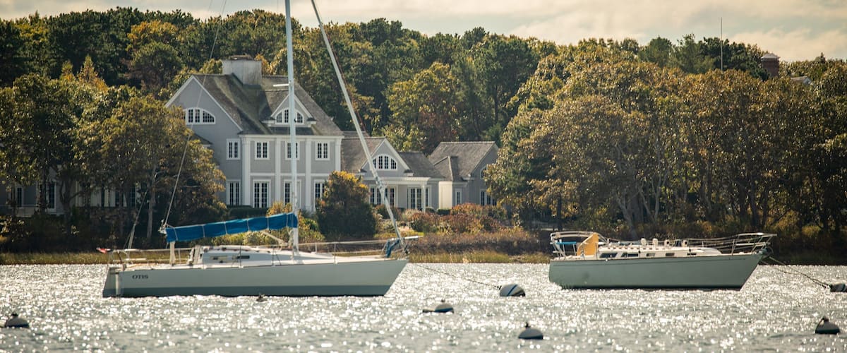 A house by a lake with boats.