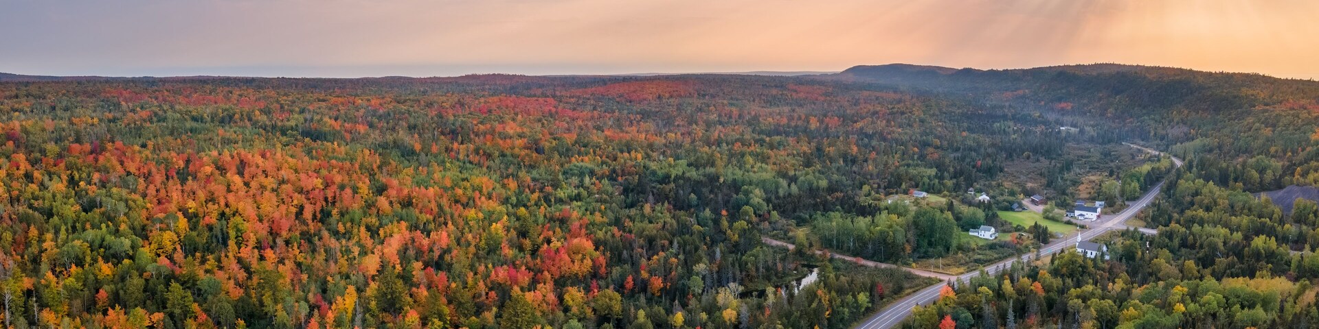 Sunset Autumn drive through the tunnel of Trees in Michigan Upper Peninsula UP - Highway 41 M26 Aerial view