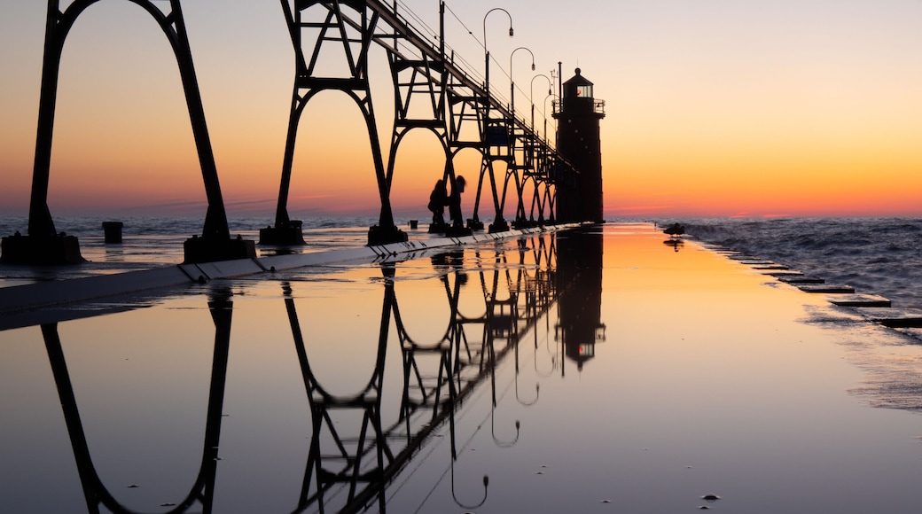 Lighthouse at beautiful sunset, symmetric mirror reflection, South Haven Lake Michigan