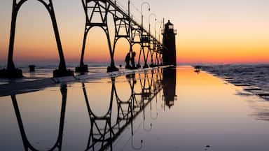 Lighthouse at beautiful sunset, symmetric mirror reflection, South Haven Lake Michigan