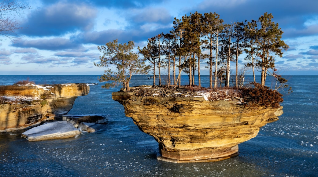 Morning sun lights up a rock formation on Lake Huron. Locally known as Turnip Rock, it is a popular destination for kayakers during the summer season. Pancake ice begins to form.