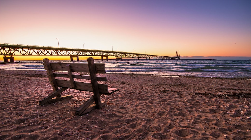 Mackinaw Bridge Twilight.. Park bench on the shores of the Mackinac Straits with the Mackinaw Bridge at the horizon.