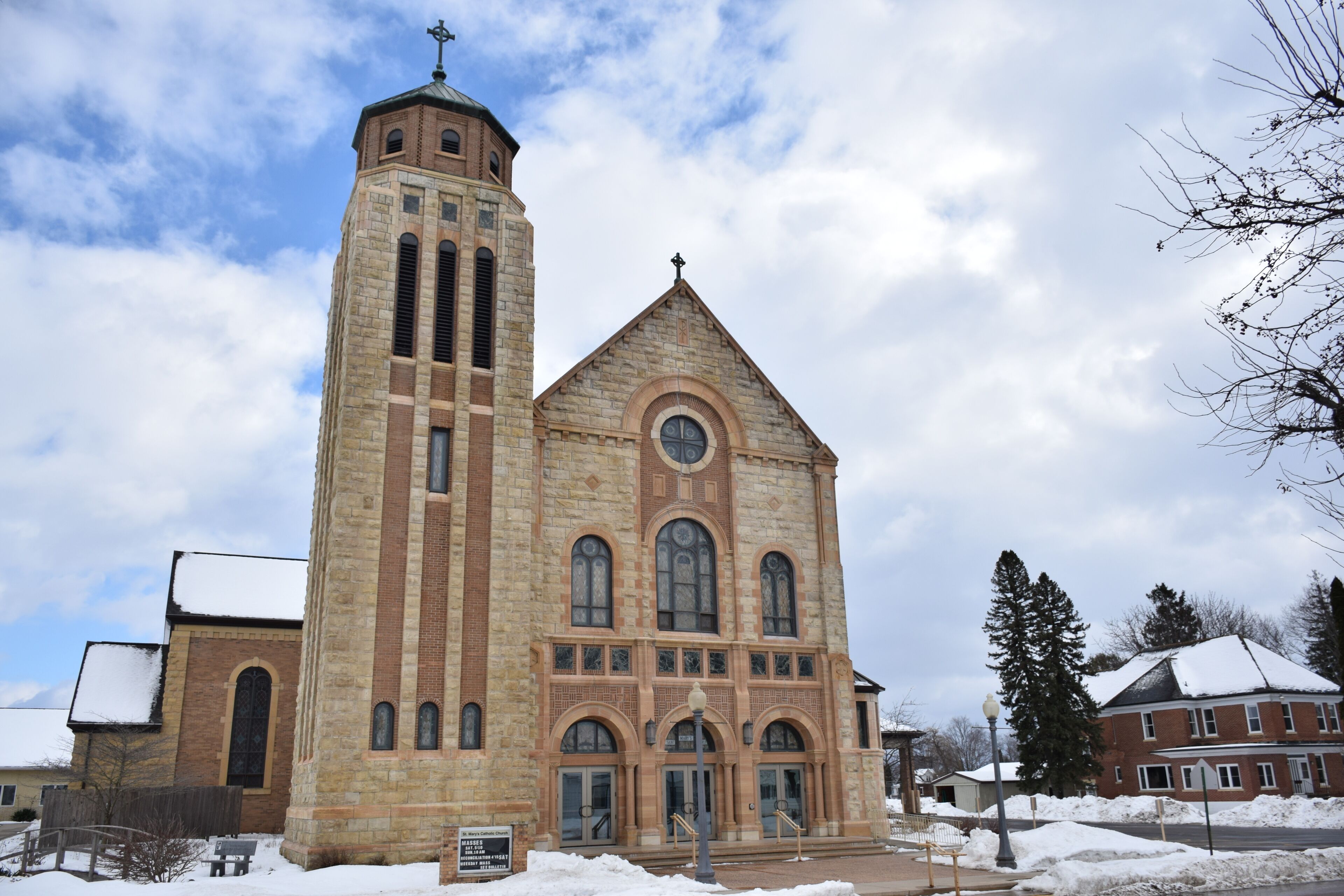 A large brick church with a tall tower and arched windows.
