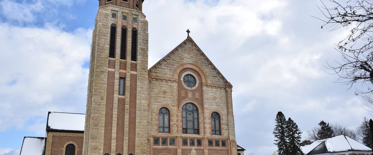 A large brick church with a tall tower and arched windows.