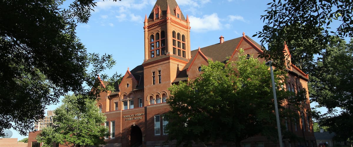 A historic courthouse with a prominent tower and arched entrance.