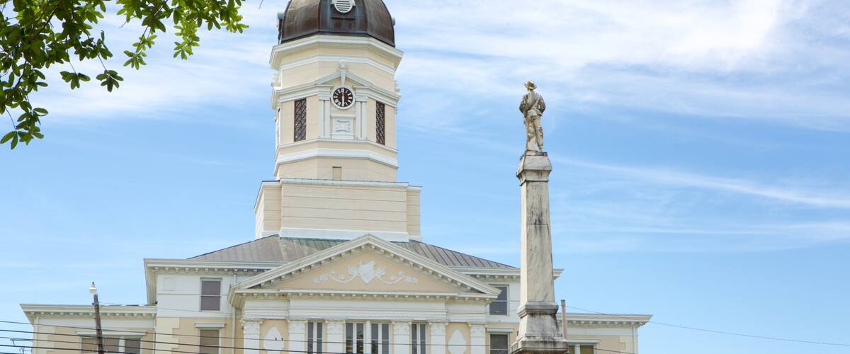 Port Gibson featuring a statue or sculpture, an administrative buidling and heritage architecture