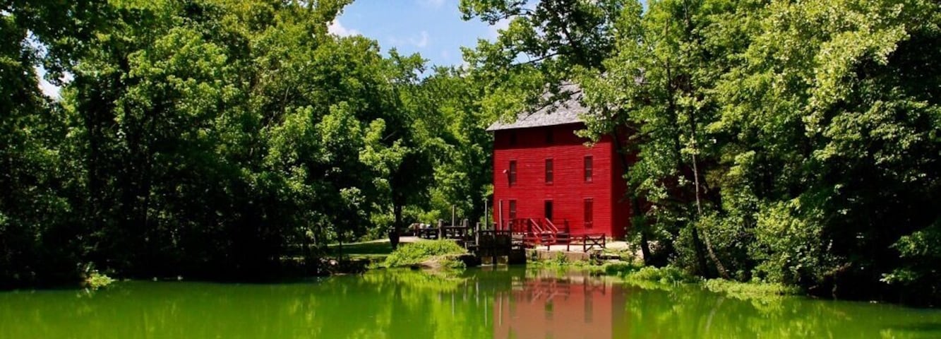 Alley Spring
This is a beautiful part of the country. Deep valleys, tall rolling hills, beautiful trees. The mill sets back off the road a bit. When you cross the bridge to approach the mill, the temperature drops considerably because of the cold spring. Such a stunning location.
Alley Spring is located at the foot of a picturesque limestone bluff. The beautiful red Alley Mill is located on its bank, utilizing its perennial flow of water to operate its turbine powered flour mills. The spring has an average daily flow of 81 million gallons of water. During most times the water is a placid azure blue, gently welling up from below, but after a storm has swelled the underground conduits feeding the spring, it can gush forth in angry swells and splashes of brown.
The Alley Spring Roller Mill, also known as Red Mill, is a historic grist mill located in the Ozark National Scenic Riverways near Eminence, Shannon County, Missouri. It was built in 1893, and is a 2 1/2-story, rectangular frame building on a limestone block foundation. It measures 32 feet by 42 feet and houses four steel rollers and a single stone burr.
You can tour the mill. The equipment is still inside and the Park Rangers are incredibly knowledgeable!
It was listed on the National Register of Historic Places in 1981.
(Alley Mill is located six miles west of Eminence, Mo on State Route 106)
#LIFEATEXPEDIA #OZARKS #ALLEYSPRING #WATERMILL #NATIONALPARKSERVICE #STAYCATION #IHEARTTRAVEL