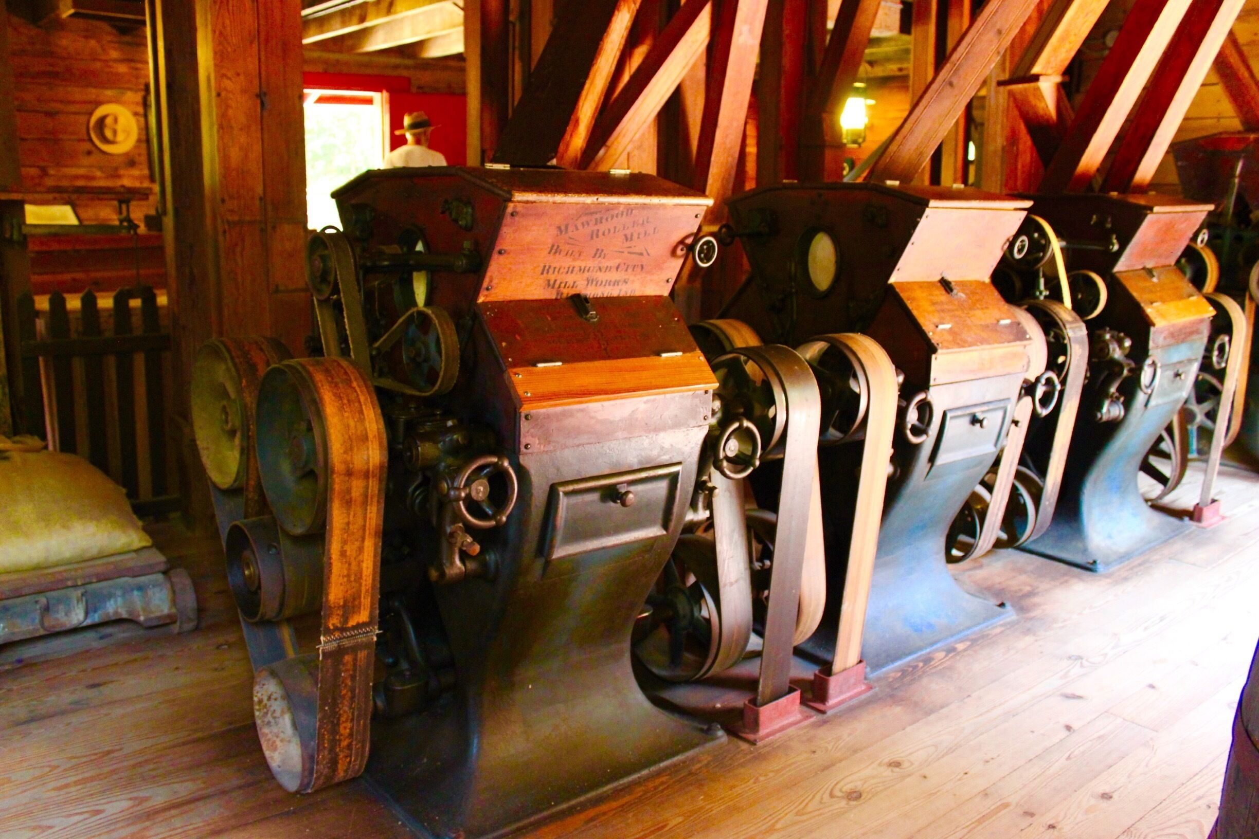 An old wooden mill with large gears and machinery.