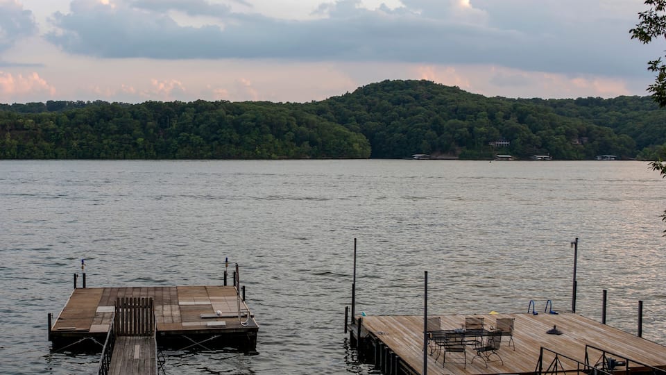 A calm lake with wooden docks extending into the water.