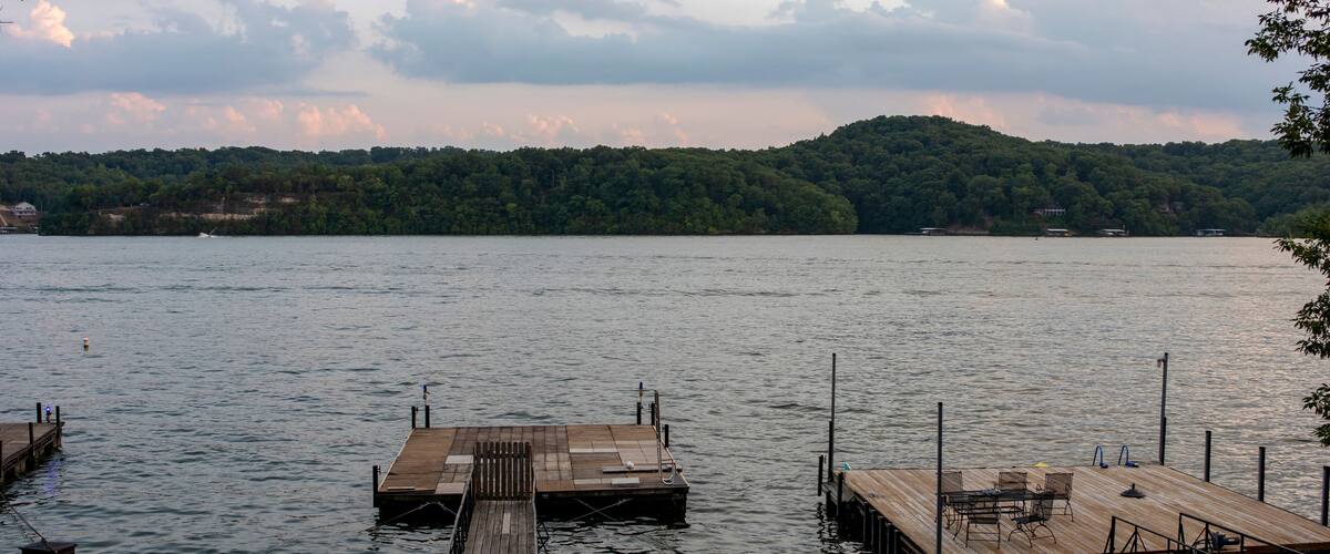 A calm lake with wooden docks extending into the water.