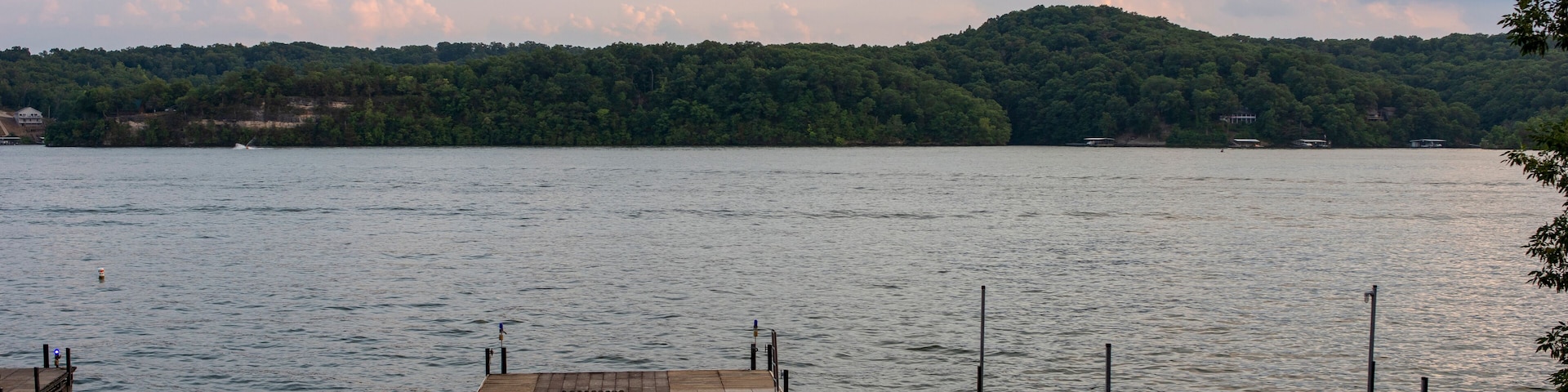 A calm lake with wooden docks extending into the water.