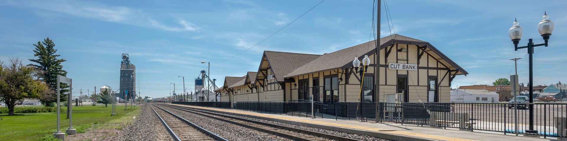 A railway station with multiple tracks and a building labeled "CUT BANK".