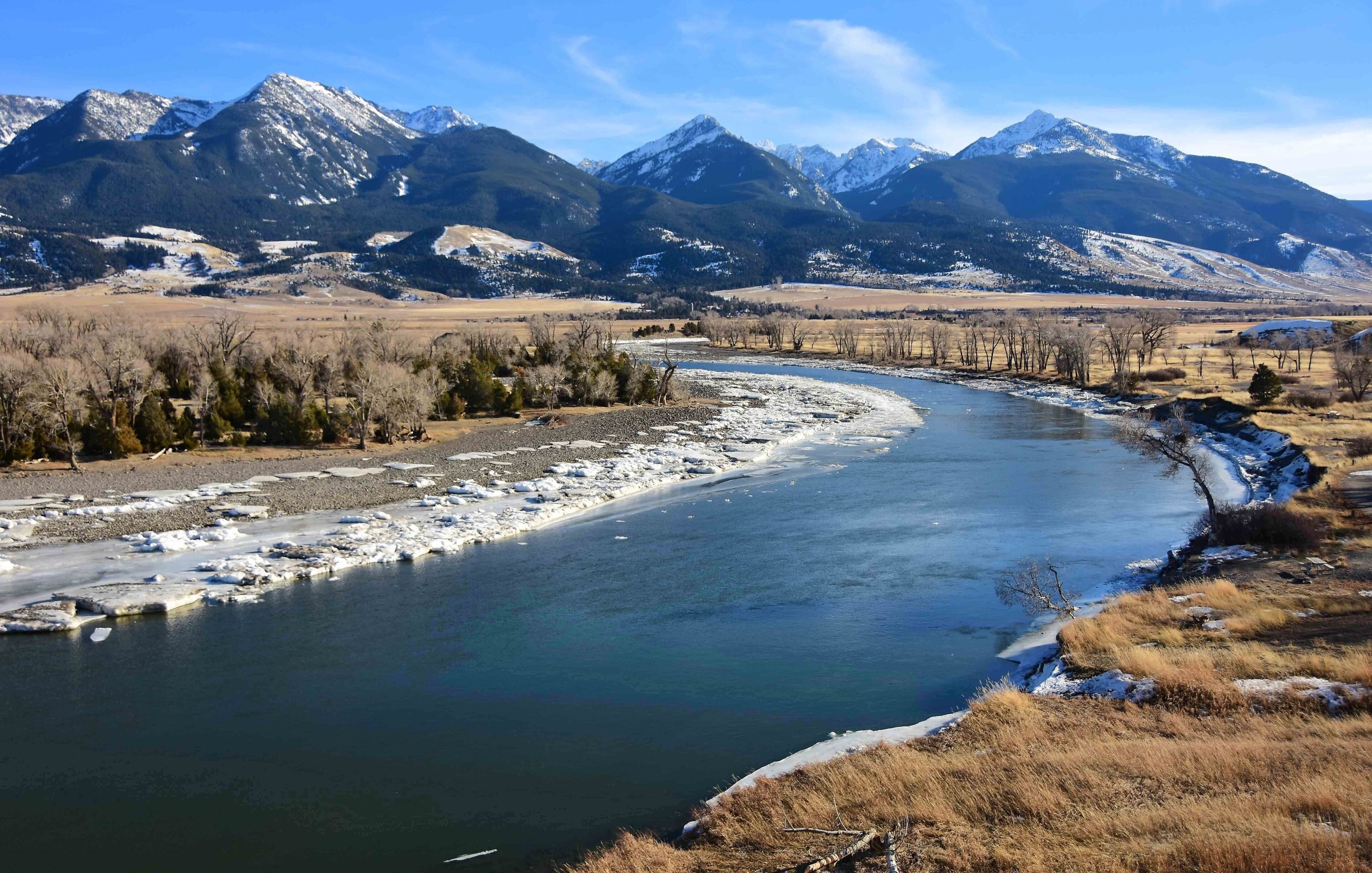 scenic winter landscape on a sunny day  at mallard's rest fishing access along the paradise valley scenic loop of the yellowstone river and gallatin range, south of livingston, montana
