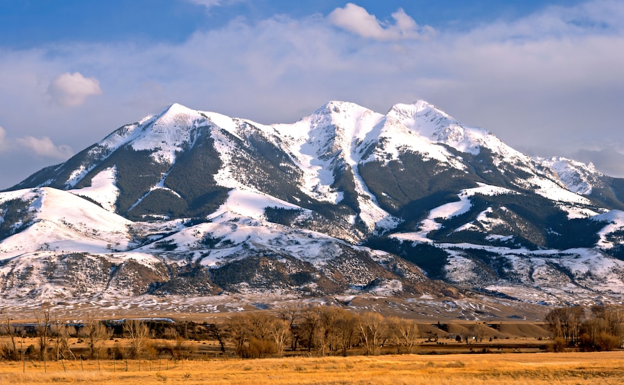 A snow-covered mountain range with a clear sky.