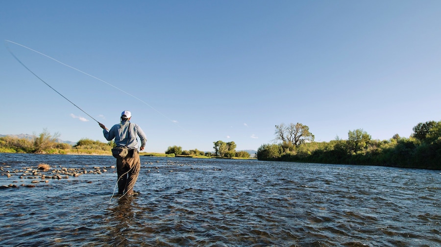 Ennis showing a river or creek and fishing as well as an individual male