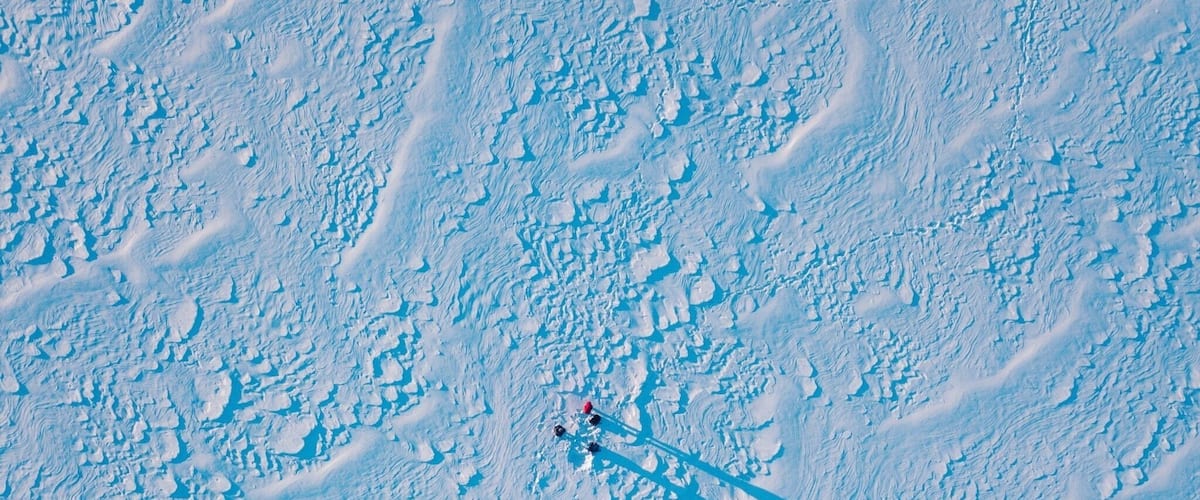 A snowy landscape with a ski slope and a ski lift.