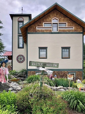 There was a church at this lot which burned down so the present owner built a smaller version for their home and used the original bell. She sells art and plants. (June 2019)