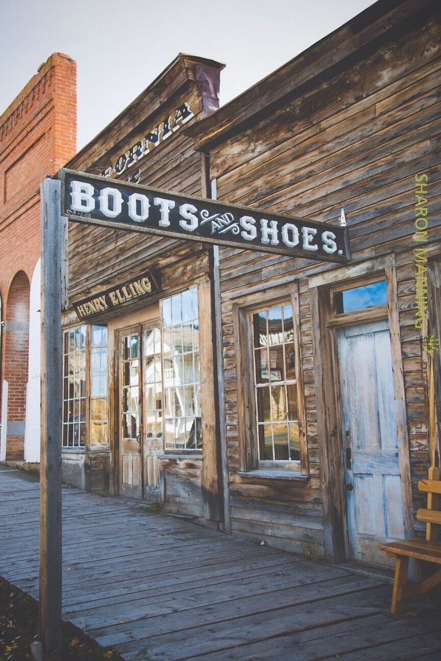 A wooden storefront with a sign that reads "Boots & Shoes."