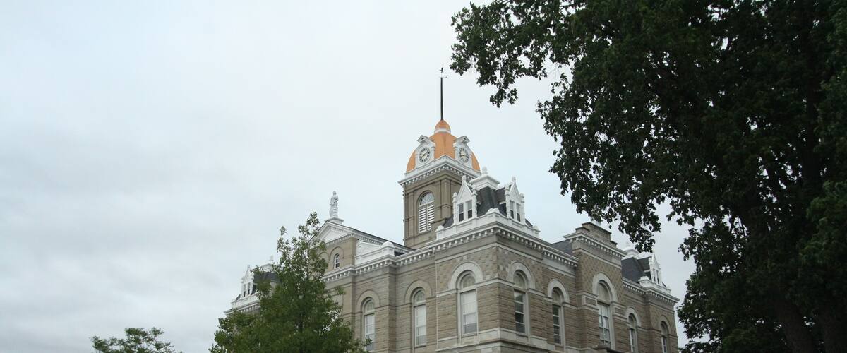 A large, historic building with a prominent dome and clock tower.