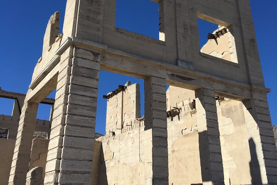 Ancient ruins with large stone blocks and columns.