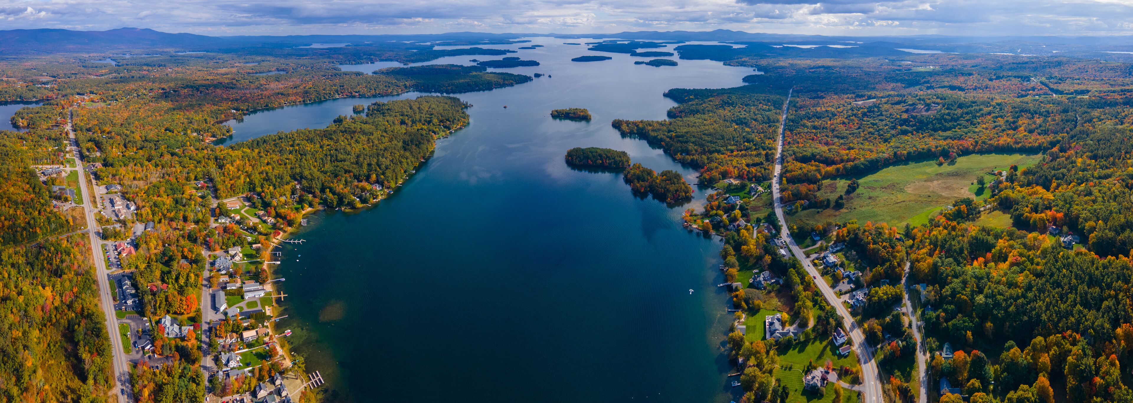 Panoramic aerial view of Center Harbor Bay in Lake Winnipesaukee in fall from town center of Center Harbor, New Hampshire NH, USA. 