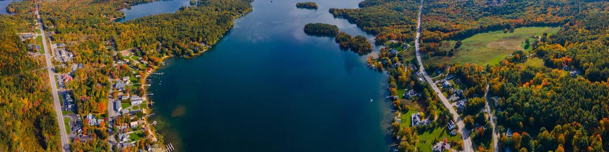 Panoramic aerial view of Center Harbor Bay in Lake Winnipesaukee in fall from town center of Center Harbor, New Hampshire NH, USA.