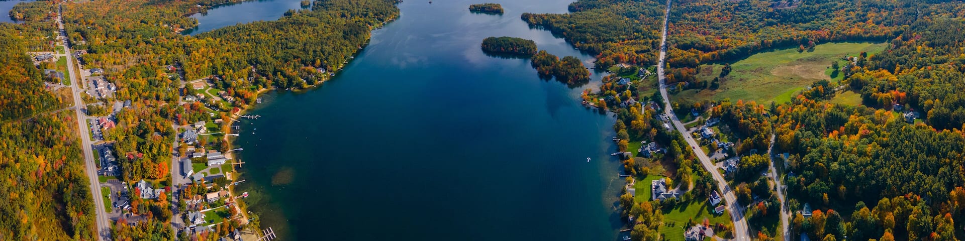 Panoramic aerial view of Center Harbor Bay in Lake Winnipesaukee in fall from town center of Center Harbor, New Hampshire NH, USA.