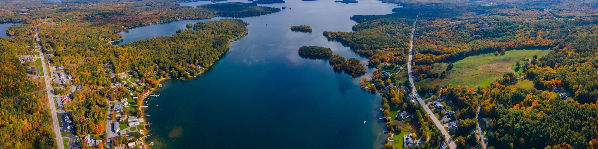 Panoramic aerial view of Center Harbor Bay in Lake Winnipesaukee in fall from town center of Center Harbor, New Hampshire NH, USA.