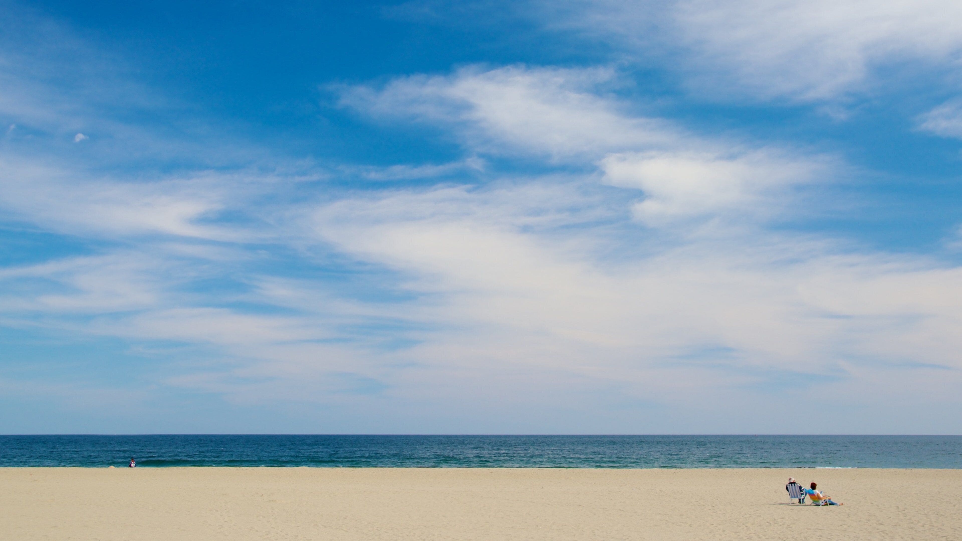Hampton Beach featuring a sandy beach as well as a couple